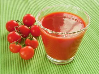 Tomato juice and sprig of cherry tomatoes, close-up