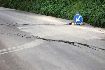 Damaged road with big cracks