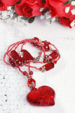 red heart necklace on lace