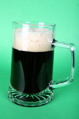 Beer mug on green background