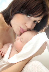 Obraz premium Happy mother with a baby