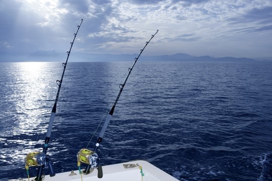 Fishing boat trolling with two rods and reels