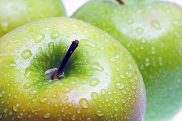 Apples in drops of water close-up