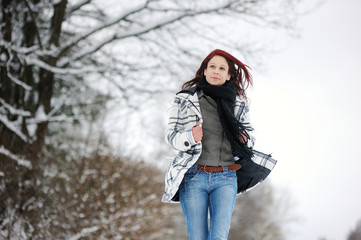 Fototapeta na wymiar Young woman in snowy forest