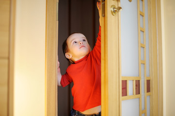 Little girl trying to open a door