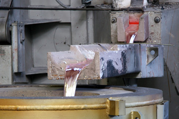 liquid aluminium, coming out an oven in a factory