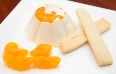 Delicious pudding with orange and biscuits