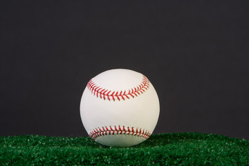 New baseball on black background