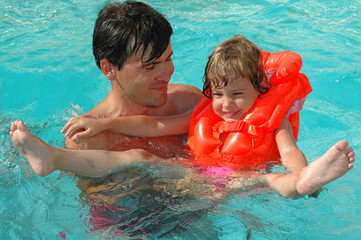Father with child in water pool