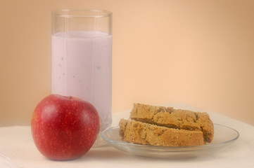 Home made bread, glass of yogurt and an apple