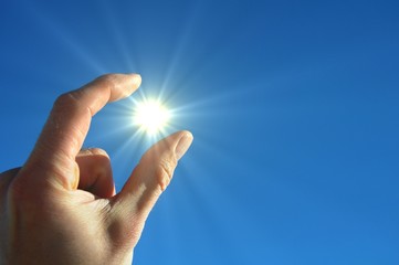 hand sun and blue sky