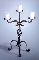 Tall iron candelabra with three candles