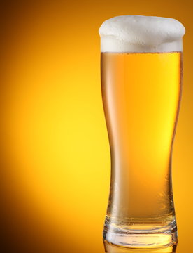 glass of beer on a yellow background