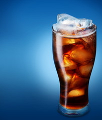 Glass of cola with ice on a blue background