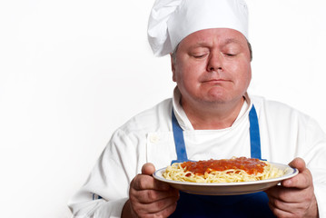 Portrait of happy attractive cook with spaghetti