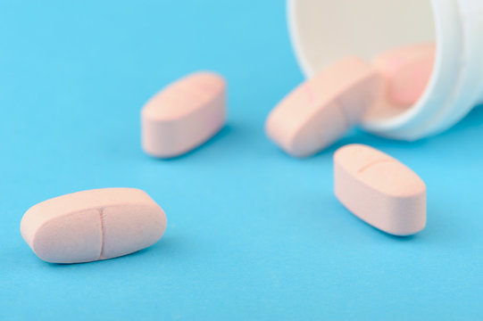 Pink tablets in white plastic packing