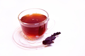 Cup of tea with a mint leaf on a white background.