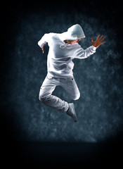 modern dancer poses in front of the old dirty wall.