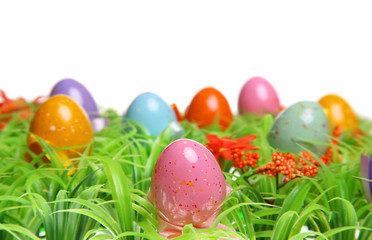 Fototapeta na wymiar Colorful Easter Eggs On Green Grass. Isolated on white.