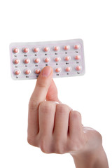 The pill - hand holding contraceptives isolated on white