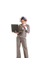 Business woman with curlers and laptop