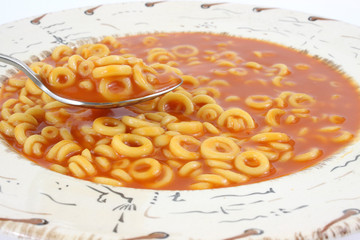 Tomato soup and pasta rings with a spoon