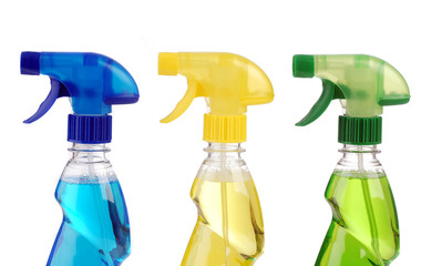 Transparent spray bottles on white background