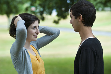 Teenage couple conversing in park