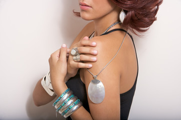 female model wearing silver jewelry earrings pendant bands