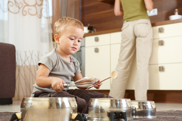 Little boy playing in kitchen