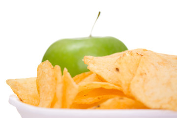 Fototapeta na wymiar Chips on dish and apple
