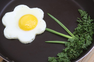 Flower shaped fried egg with greenery