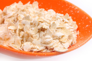 oat cereal in plastic spoon close up or macro