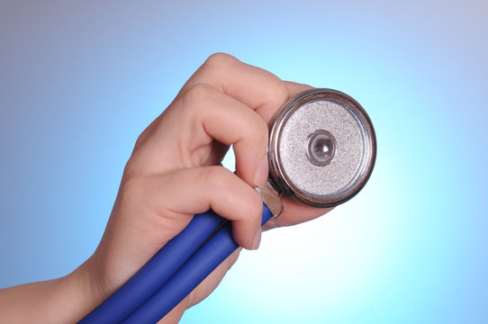 Health care concept. Female hand holding stethoscope