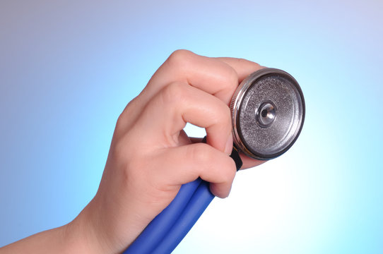 Health care concept. Female hand holding stethoscope