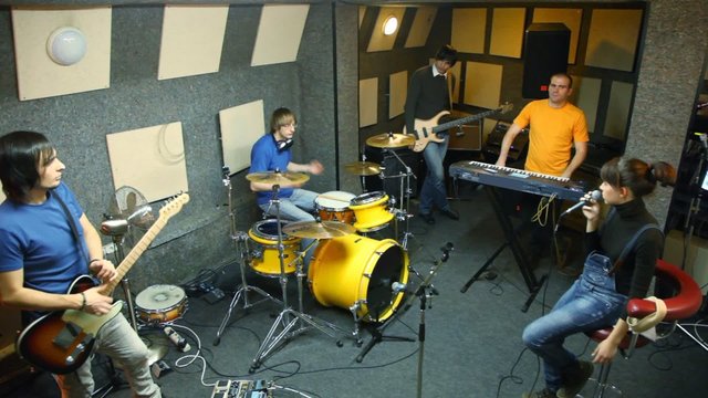 musical group of five persons in studio
