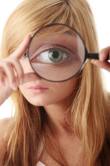 Young teenage girl with magnifier