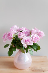 Pink roses on gray wall