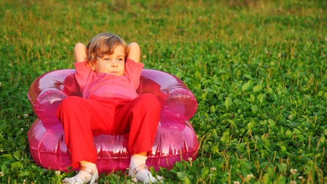 girl sit in children's inflatable armchair
