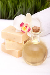 Spa orchid on soap towels and essential oils