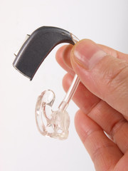 Hand holding hearing aid