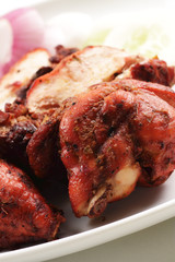 Close-up of a plate of chopped tandoori chicken