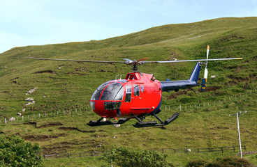 Helicopter flying over Scottish farmland
