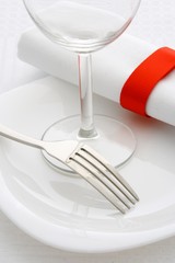 Forks and wine glass on a white plate