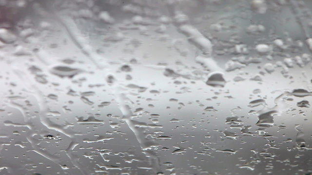 Snow and rain in cars traffic view from wet glass window