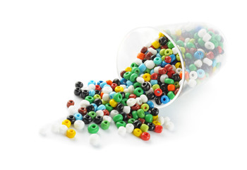 colored glass beads in small glass. Isolated comosition.