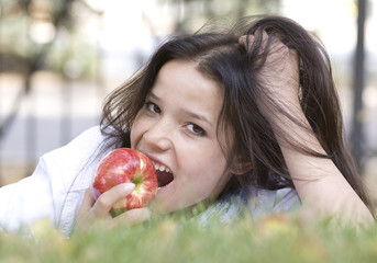 Woman with apple at the summer park