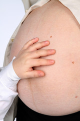 pregnant woman and her son holding belly closeup