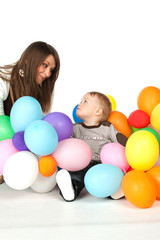 Fototapeta na wymiar Mother and son playing party balloons