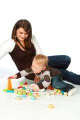 Mother and son playing wooden cubes